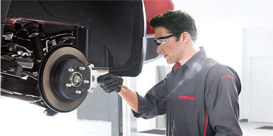 mechanic working on brakes